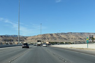 18 miles from the Henderson Bowl interchange (I-11), CC-215 and the Bruce Woodbury Beltway turns north toward Summerlin and northern reaches of Las Vegas.