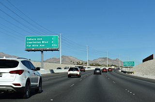 CC-215 (Bruce Woodbury Beltway) re-curves north between the Gardens and Ridgebrook neighborhoods one mile out from Exit 25 with Sahara Drive.