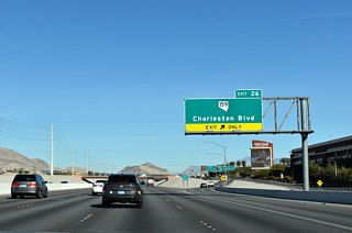Crossing over Summerlin Centre Drive, Exit 26 leaves CC-215 north for Hughes Park Drive E to SR 159 (Charleston Boulevard).