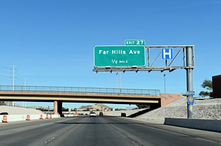 CC-215 passes under Alta Drive 0.50 miles out from the SPUI with Far Hills Avenue. Far Hills Avenue joins the beltway with the Arbors neighborhood of Summerlin.