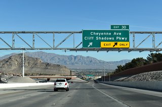 Two lanes depart from the Bruce Woodbury Beltway (CC-215) at Exit 30 for Cheyenne Avenue and Cliff Shadows Parkway.