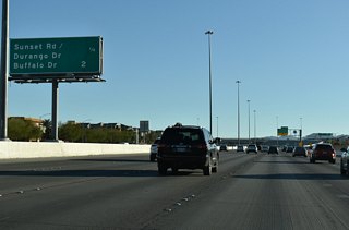 Exit 16 with Buffalo Drive joins Clark County Route 215 south with western reaches of Enterprise in two miles. 