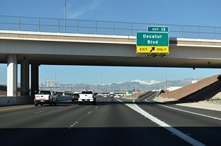 Passing under Dean Martin Drive, Exit 13 leaves Clark County Route 215 (CC-215) for Decatur Boulevard.