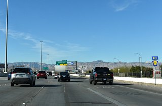 Westbound CC-215 (Bruce Woodbury Beltway) advances to Rainbow Boulevard next at Exit 15.