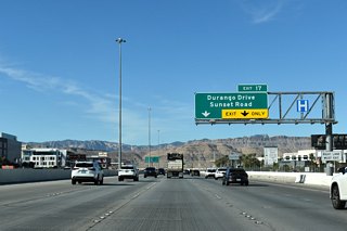 Blue Diamond Hill (el. 4,956 feet) and the Sandstone Bluffs become more visible as CC-215 advances west one half mile to Durango Drive / Sunset Road.
