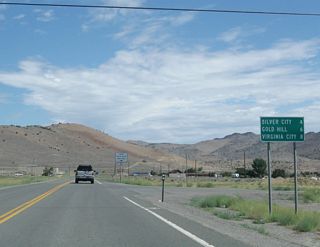 Nevada 341 (Comstock Highway) north distance sign for Silver City (four miles), Gold Hill (six miles), and Virginia City (eight miles).
