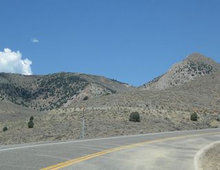 Nevada 341 continues to gain elevation en route to Virginia City. Evidence of prior mining activity can be seen throughout this area from very old and more recent claims.