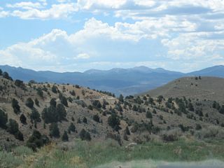 Nevada 341 (Occidental Grade) turns toward the northwest. Views of Gold Hill to the west and back toward Silver City are afforded by looking south and west from the highway.