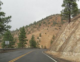 Continuing west across the Virginia Range, Nevada 341 (Geiger Grade) enters Washoe County ahead of suburban areas in south Reno.