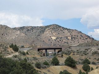 This view looks north at the Nevada 341 (Occidental Grade) bridge over the Virginia & Truckee Railroad in southern Virginia City.