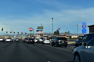 The diamond interchange joining Sunset Road with Interstate 11 follows the signalized intersection with Marks Street eastbound.