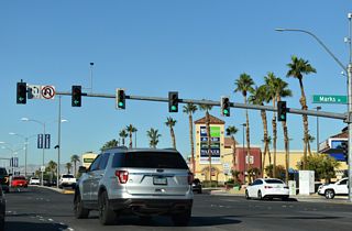 Sunset Road enters a commercialized intersection with Marks Street west of Interstate 11.