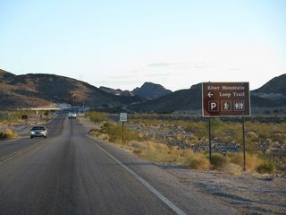 Lake Mead Parkway westbound passes the National Recreation Area pay station ahead of the River Mountains Loop Trailhead.