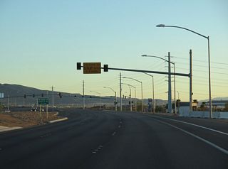 Curving southwest by the Calico Ridge community, SR 564 (Lake Mead Parkway) advances to the traffic light with Olsen Street north and Athens Avenue east.