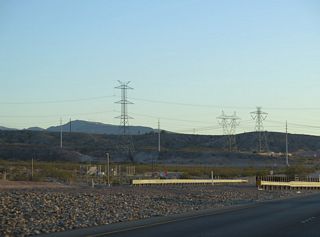 A series of power transmission lines span SR 564 within the vicinity of the Lake Mead Parkway Trail under crossing. The highest towers are also the newest; erected as part of Nevada Power's Centennial Project.