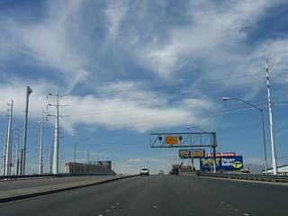 Sahara Avenue elevates onto a viaduct spanning Industrial Avenue, a Union Pacific Railroad line and Western Avenue ahead of I-15.