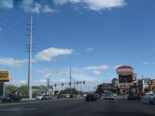 Beyond the traffic signal for the Tuscany resort-casino, eastbound Flamingo Road next intersects Paradise Road (former SR 605). Paradise Road heads north to Downtown Las Vegas and south to Harry Reid International Airport (LAS).