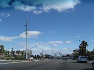 A quad-circuit Nevada Power line (likely 138kV/69kV) parallels Flamingo Road east beyond the Strip.