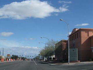 Eastbound Flamingo Road (Nevada 592) meets Escondido Street at the Clark County Public Library. Nevada 592 next approaches the traffic signal intersection with Algonquin Drive and Viking Road north and Tamarus Street south.
