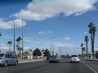 Palm trees and power lines follow Flamingo Road (Nevada 592) east after Eastern Avenue.