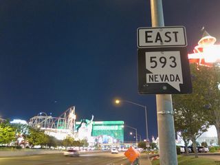 A previous SR 593 shield posted adjacent to the Excalibur resort and ahead of Las Vegas Boulevard (Former SR 604/U.S. 91-466). The MGM Grand resort appears beyond the New York New York hotel & casino.
