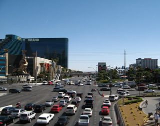 Looking east from the pedestrian bridge between Excalibur resort and New York New York resort, this view shows eastbound Nevada 593 (Tropicana Avenue) at the intersection with Las Vegas Boulevard (former Nevada 604).