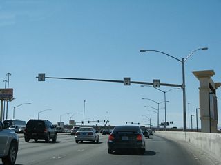 Another ground-level view shows the tiny white signs that show the lane allocation from Nevada 593 (Tropicana Avenue) to Interstate 15 north and south.