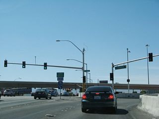 The first right from westbound Nevada 593 (Tropicana Avenue) connects to Interstate 15 north to downtown Las Vegas. A freeway entrance shield assembly is posted on the traffic island between the travel lanes.