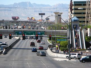 Returning to the traffic signal between westbound Tropicana Avenue and Las Vegas Boulevard, green guide signs provide the lane allocations for the connection to Interstate 15 north and south. Stay left for Interstate 15 south to Primm and all points in Southern California; stay right for Interstate 15 north to downtown Las Vegas and points north.