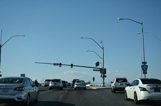 The ramps at the diamond interchange (Exit 15) joining CC-215 with Rainbow Boulevard tie into Roy Horn Way eastbound and Rafael Rivera Way westbound, the frontage road system for the Bruce Woodbury Beltway.