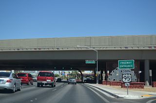 A single point urban interchange (SPUI) joins the south end of U.S. 95 Business and SR 599 (Rancho Drive) with I-11/U.S. 95.