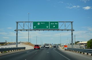 Ramps from SR 599 partition to both the I-11/U.S. 95 freeway mainline and a distributor roadway (Exit 90 B) to Ann Road.