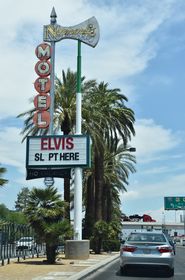 The vintage Normandie Motel neon sign precedes Mesquite Avenue northbound from within the median of Las Vegas Boulevard.