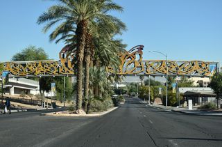 A pedestrian bridge spans Las Vegas Boulevard as part of the Pioneer Trail by  Heritage Park, Old Las Vegas Mormon Fort State Historic Park and the Las Vegas National History Museum.