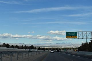 Anasazi Drive curves north from Town Center Drive to meet SR 613 (Summerlin Parkway) at a diamond interchange. The arterial continues north into the Sun City neighborhood of Summerlin.