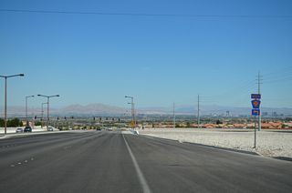 Summerlin Parkway begins at a parclo interchange with CC-215 (Woodbury Beltway).