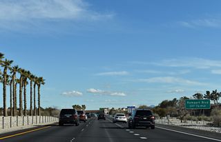 SR 613 (Summerlin Parkway) curves southeast from the commercial center of Summerlin to meet Rampart Boulevard in a half mile.