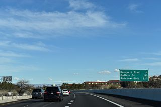 The exit for Rampart Boulevard departs two miles ahead of the Summerlin Parkway east end at SR 595 (Rainbow Boulevard) and I-11/U.S. 95.
