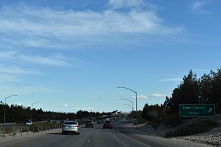 Town Center Drive arcs southwest from Village Center Circle to Charleston Boulevard (former SR 159).