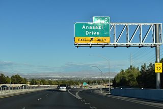 Anasazi Drive curves north from Town Center Drive to meet SR 613 (Summerlin Parkway) at a diamond interchange (Exit 0). The arterial continues north into the Sun City neighborhood of Summerlin.