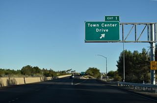 Town Center Drive arcs southwest from Village Center Circle to Charleston Boulevard (former SR 159).