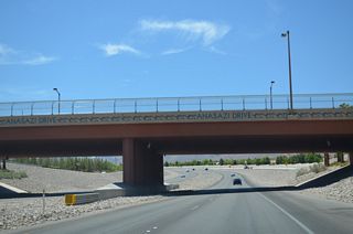 Continuing 0.8 miles north from the overpass above Summerlin Parkway, Anasazi Drive connects with Lake Mead Boulevard and Sun City Boulevard at the Sun City neighborhood of north Summerlin.