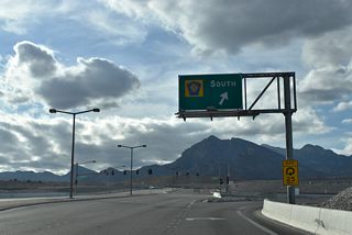 A loop ramp joins CC-215 (Las Vegas Beltway) south to I-15 near Harry Reid International Airport (LAS) and the south end of the Las Vegas Strip. Sunset Run Drive extends west to future villages of Summerlin.