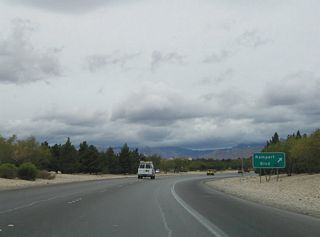 A parclo interchange joins Rampart Boulevard with Summerlin Parkway. Rampart Boulevard curves northward from Charleston Boulevard (old SR 159) alongside The Canyons, The Hills South and The Hills neighborhoods of Summerlin to Lake Mead Boulevard.