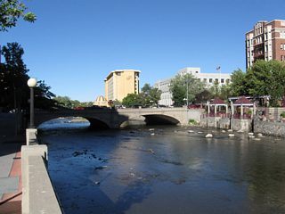 The 1905 Virginia Street bridge over the Truckee River is a double-concrete arch bridge; this view looks east from the Sierra Street bridge. This bridge carries U.S. 395 Business and SR 430 over the river. Plans call for replacement of the Virginia Street bridge (along with the Sierra Street and Lake Street bridges over the Truckee River) in the 2010s as part of the Truckee River Flood Project due to flooding issues in downtown Reno (a devastating flood struck the area in 1997). For more on the Virginia Street Bridge including history and bridge replacement proposals, see On-Line Nevada.
