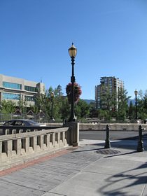 The Reno River Walk offers dining and shopping along the north and south sides of the Truckee River in downtown Reno. Looking west from the Sierra Street crossing of the Truckee River, an antique street light illuminates the intersection of the River Walk with Sierra Street (former U.S. 395 Alternate).