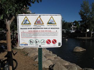 Swimmers and floaters about to use the Truckee River are warned of possible risks and perils within the swift moving waterway. This sign is found in Wingfield Park.