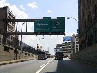 A sign bridge beyond the Holland Tunnel exit previously referenced Exit 1 for NY 9A (West Street) and Exit 2 - Uptown (Hudson Street). Those overheads were replaced with a dynamic message board by 2007.