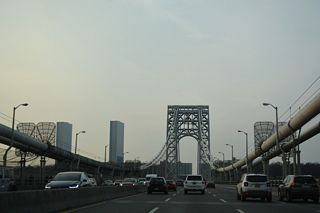 The George Washington Bridge crosses the west bank of the Hudson River into the borough of Fort Lee, New Jersey above Hazard Beach.