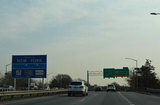 The New York welcome sign stands within the median of the Staten Island Expressway ahead of the Forest Avenue over crossing.